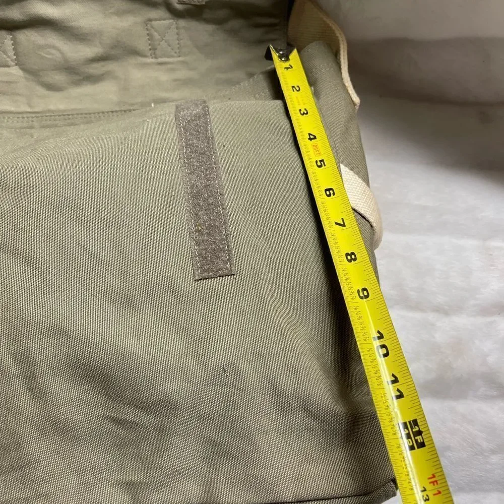 Lucky Brand large canvas olive green messenger bag with adjustable beige strap.